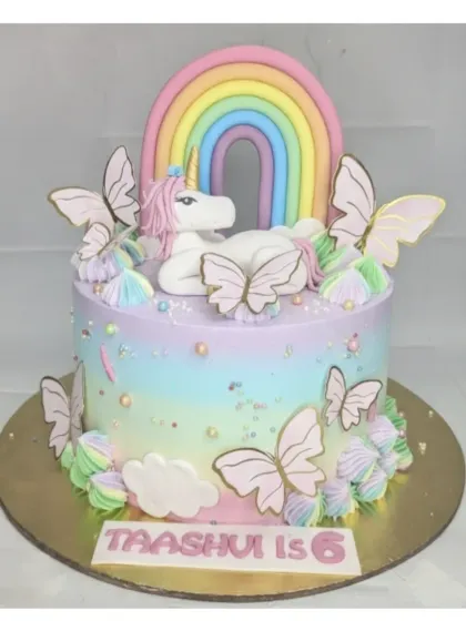A magical unicorn and butterfly cake with a chocolate truffle base. I love the pastel rainbow frosting, the fondant unicorn, and the delicate butterfly details on this custom birthday cake.