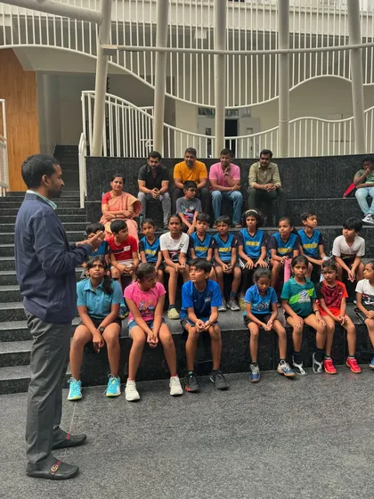 Mr. Gopichand interacting with a group of young, aspiring players, sharing his wisdom and experience in an informal session.