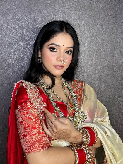 A close-up portrait showing the detail of the soft smokey eye and flawless skin.