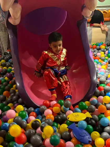 Sliding into fun! This spooky-mouthed slide is a thrilling part of our play area, leading right into the colorful ball pit.