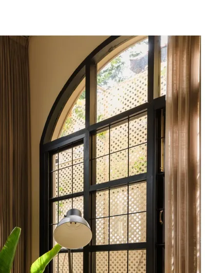 The grand, arched windows of Casa 503. These large openings are a key feature of our climate-responsive design, allowing for ample natural light while framing the beautiful green landscape.