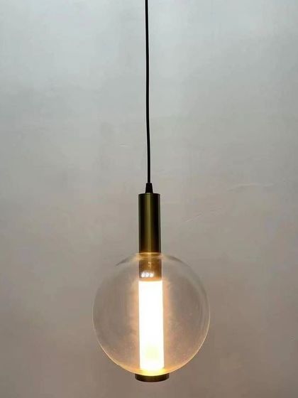 A minimalist hanging lamp featuring a clear glass globe with an internal tube light. This simple and modern design provides clean, bright light, making it a versatile choice for various contemporary settings.