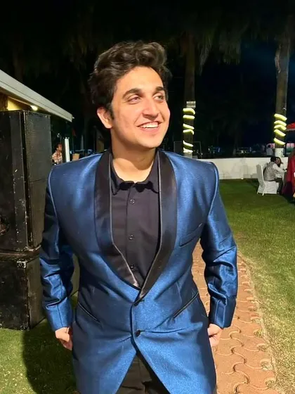 Dressed in a sharp, metallic blue suit for an evening event. This look is perfect for formal wear, events, or luxury brand modeling.
