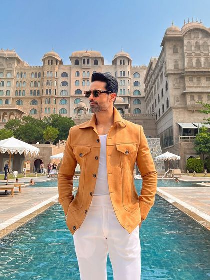 The jacket is pictured at a luxury resort, reinforcing its status as a premium travel and leisure garment.