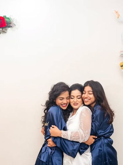 A sweet moment of friendship as the bride and her bridesmaids share a group hug.