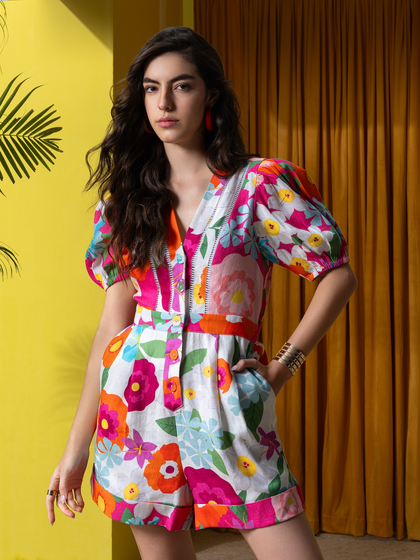A three-quarter shot of a floral romper from the Boho-Chic collection, set against the vibrant yellow and orange backdrop we constructed.