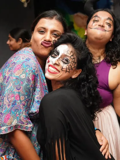 Making funny faces and having a great time with friends during our Halloween event. It's all about letting go and being yourself.