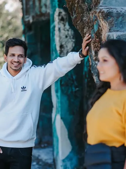 A sweet, candid moment between the couple at a rustic location in Mussoorie. The natural interaction and loving gaze are what make this photo special.