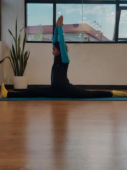 This is Charvi, the inspiration behind our kids' yoga program. Her dedication is incredible, and here she demonstrates a perfect center split, showcasing the flexibility and discipline that yoga helps cultivate.