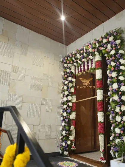 Main door decor for a housewarming ceremony. A beautiful floral arch welcomes guests into the new home.