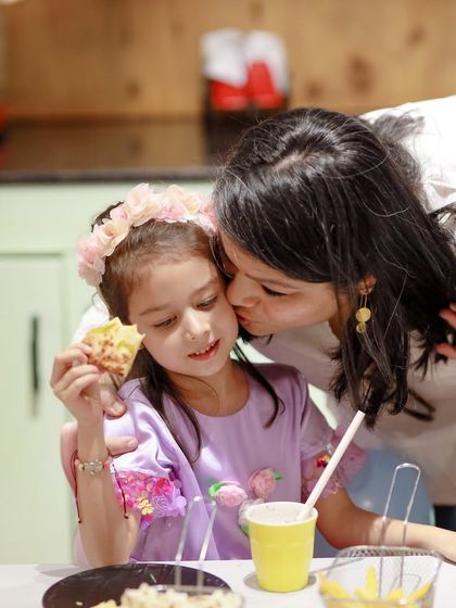 A tender moment between a mother and her daughter as they enjoy a snack in our cafe area.