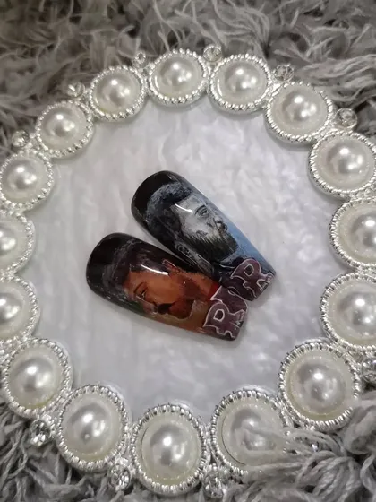 A close-up of the RRR movie character portraits on two nails.
