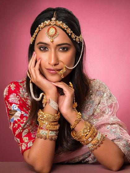 A close-up portrait from the same shoot, focusing on the beautiful matha patti and nath that frame the model's face, adding a touch of Rajasthani-inspired elegance.