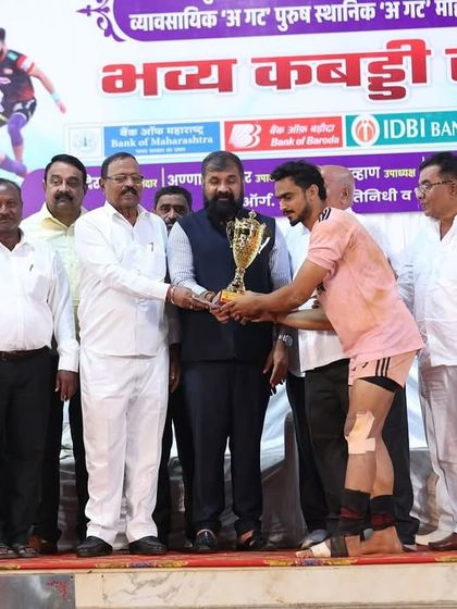 A player receiving the 'Best Player of the Tournament' trophy from officials.