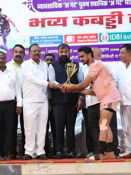 A player receiving the 'Best Player of the Tournament' trophy from officials.