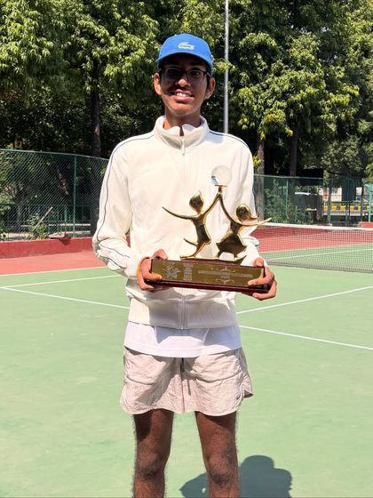 A full-length shot showing Lakshmi with his well-deserved Global Child Prodigy trophy. We work on building not just skill but also poise and confidence, preparing our athletes for success on and off the court.