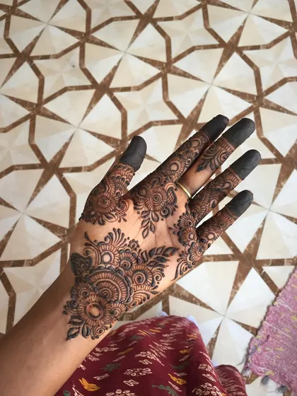 An intricate and beautiful design for the palm, featuring a central mandala and detailed floral work.
