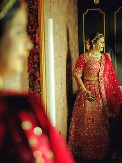 A creative getting ready shot using a mirror reflection to add depth and artistry. This style of photography adds a unique and thoughtful touch to your wedding album.