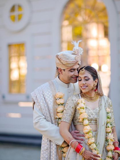 A classic portrait of the couple in their beautiful day-wedding attire, sharing a quiet, happy moment together.