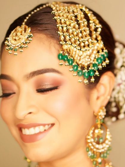 A classic smokey eye with a touch of glitter is always a stunning choice. This look, created for the groom's sister, is radiant, glamorous, and perfect for a wedding celebration.