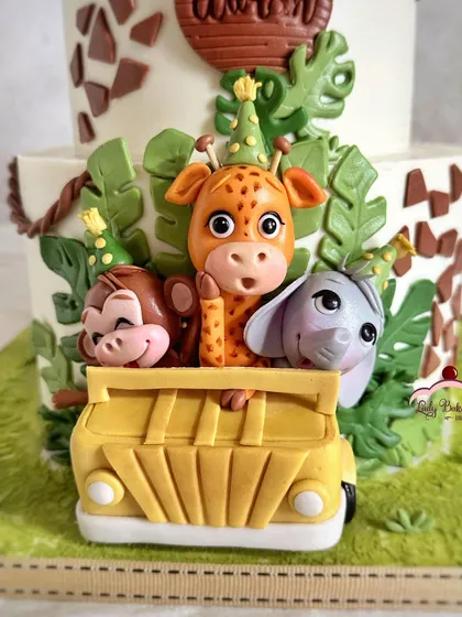 Look at these party animals! A close-up of the cheeky monkey, giraffe, and elephant peeking out of their safari jeep.