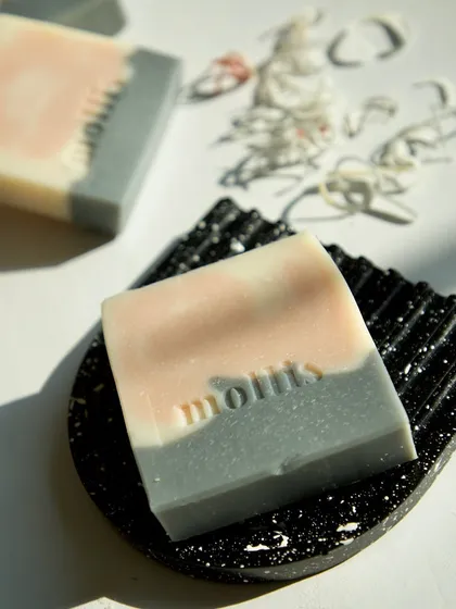 The 'Aqua' bar on a textured soap dish, showing its crisp, clean lines and gentle swirls.