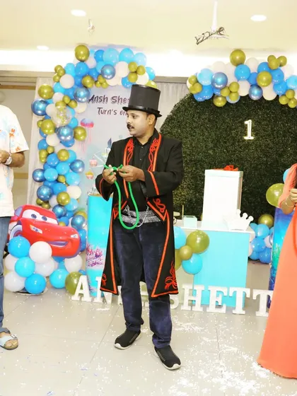 Here I am teaching a couple the basics of the linking rings trick at a birthday party. It's a great icebreaker and gets everyone involved in the fun.