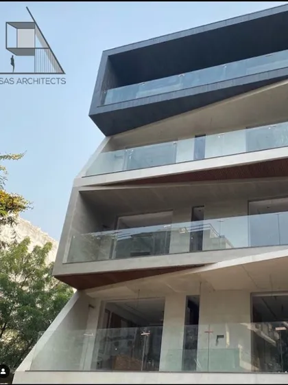 The completed project in Dwarka Sector 8. This building features a deconstructed design with angled, overlapping floors that create a visually striking and unconventional façade.