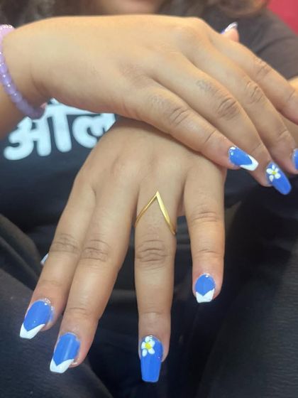 A clear shot of the finished blue and white V-French manicure. This is a great modern alternative to the classic curved French tip.