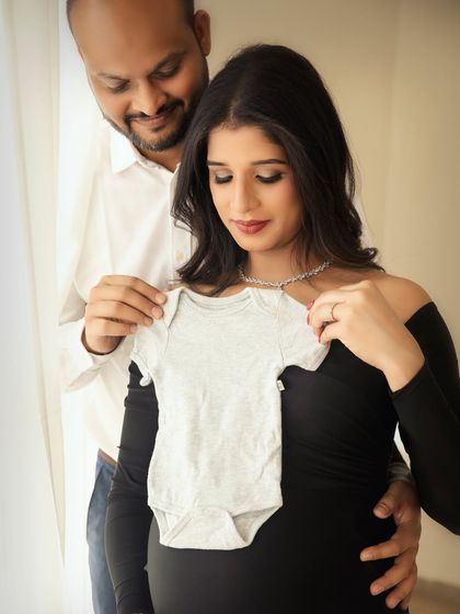 A sweet and simple announcement idea. The parents-to-be hold up a tiny baby onesie against the bump, a lovely visual that speaks volumes.