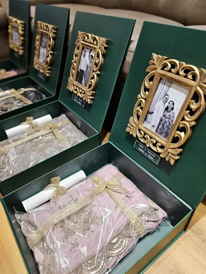I love shaping your ideas into reality. For these wedding hampers, I created custom emerald green boxes with personalized photo frames and acrylic name tags, making them super chic, classy, and elegant.