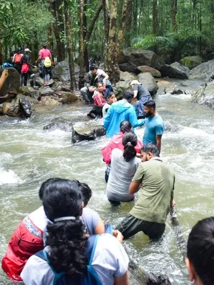 Crossing a river stream is part of the adventure on our monsoon treks, like this one on the way to Dudhsagar.