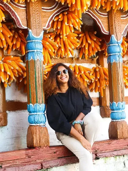 Posing against the amazing backdrop of hanging corn. My neutral-colored outfit allows the vibrant colors of the village to stand out.