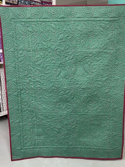 The back of the owl quilt, where the quilting creates a beautiful silhouette of the design.