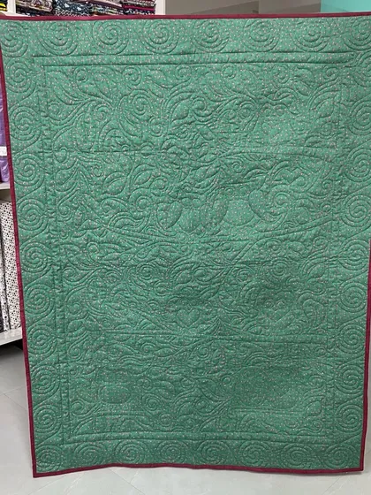 The back of the owl quilt, where the quilting creates a beautiful silhouette of the design.