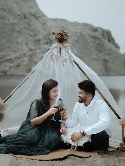 A toast to their future together. This styled pre-wedding picnic setup by the lake provides a perfect opportunity for romantic and celebratory photos.