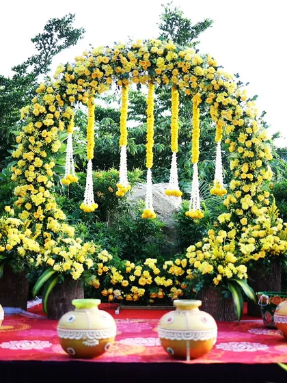 We bring vibrant traditions to life with this beautiful Haldi ceremony decor. A full circular arch made of bright yellow marigolds and contrasting white floral hangings creates a joyful and picture-perfect setting for pre-wedding festivities.