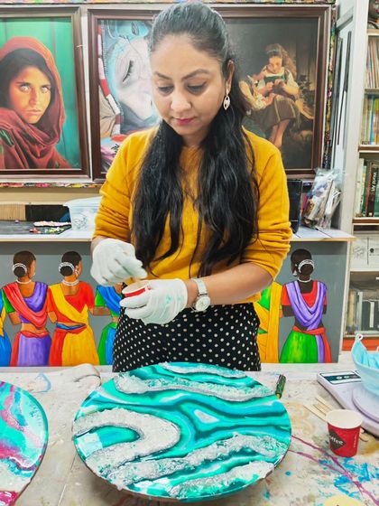 Here is a student in action, carefully adding details to her abstract resin artwork. We provide hands-on guidance at every step of the creative process.