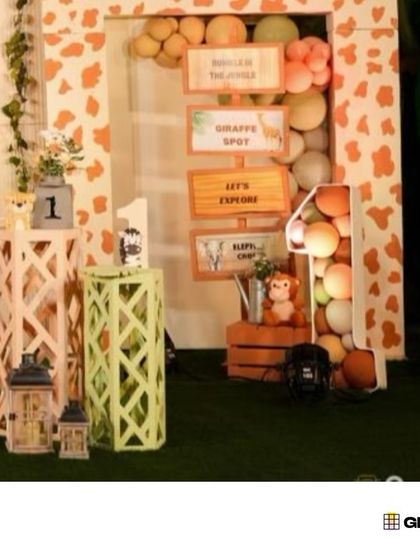 This corner of our jungle party features themed signage, decorative pedestals, and a fun photo-op area with a giraffe-print backdrop, perfect for capturing memories.