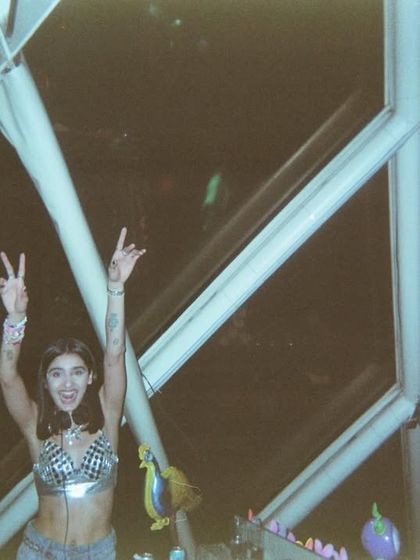 Peace and love from the DJ booth. A happy moment captured on film during a fun set.