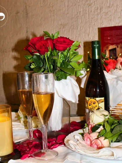 A romantic table setting for two, complete with red roses, champagne, and candlelight. I can create the perfect ambiance for your intimate anniversary dinner or proposal.