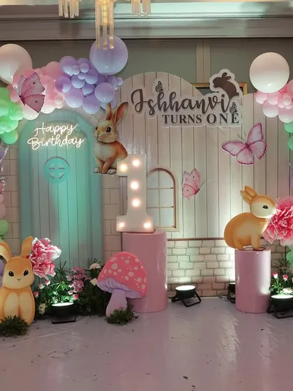 A first birthday should feel like a fairytale. For Ishhanvi's special day, I designed this whimsical bunny-themed backdrop with soft pastel balloons, adorable woodland creatures, and glowing mushrooms to create a magical setting.