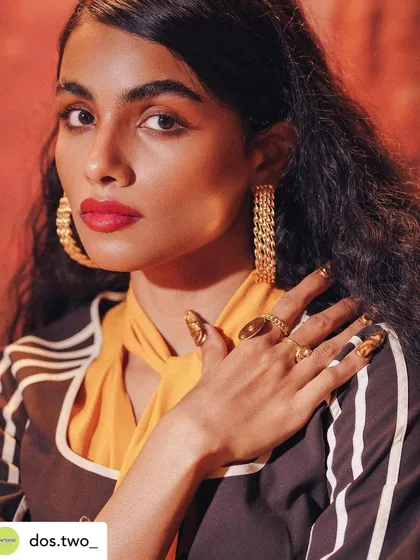 A close-up from the 70s editorial shoot, showing off the detailed, textured gold nails.
