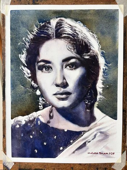 The Meena Kumari portrait on the easel, providing context for the work.