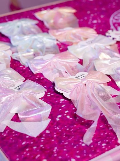 Beautiful, iridescent bows laid out as party favors for the Barbie-themed celebration.