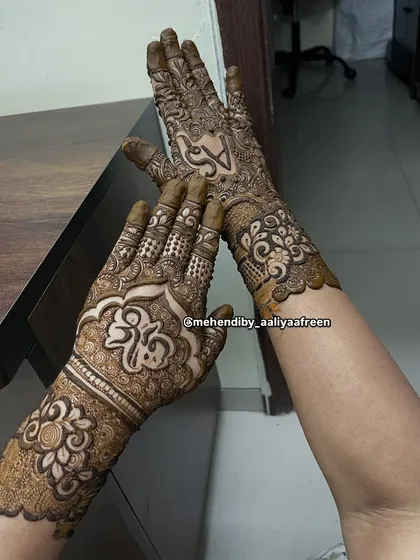 A beautiful design with names written in Arabic calligraphy, can you guess what they say?