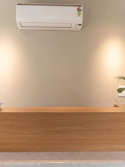 A minimalist reception desk we designed for an office space. The desk features a clean, angular design in light oak, creating a calm and welcoming first impression for visitors.