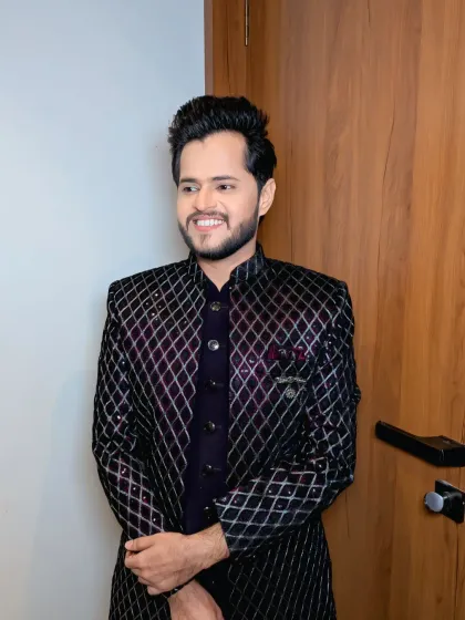 A candid, happy moment. This groom's look is perfect for a party, combining a fashionable jacket with a confident smile.