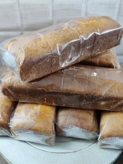 A stack of my sliced and wrapped loaf cakes, ready for a bulk order. This shows how I prepare large quantities for events or distribution.
