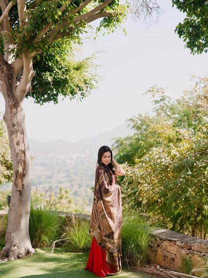 A candid shot showing the flowy dupatta of the red kurta set, perfect for an elegant and traditional look.